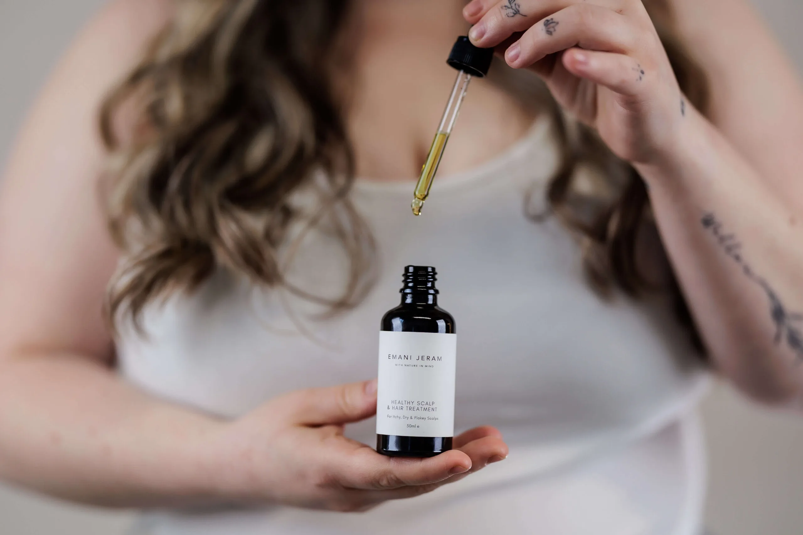 Emani Jeram Healthy Scalp & Hair Treatment held in both hands